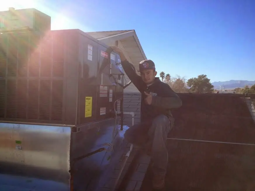 HVAC technician performing Heat Pump Repair on a rooftop unit in Jacksonville